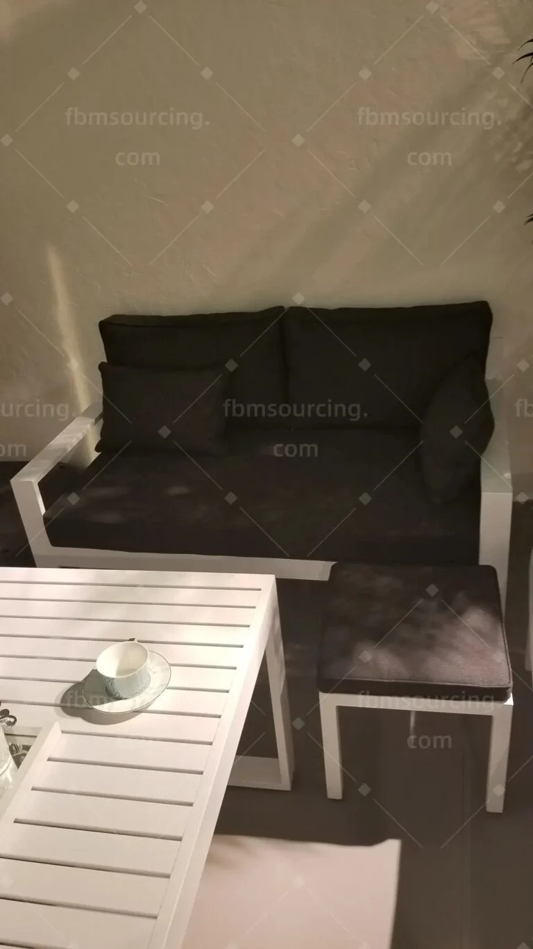 Outdoor lounge set with white aluminium frames seen in the showroom