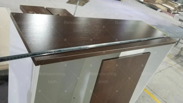 Wood-grain desk top measured with a tape