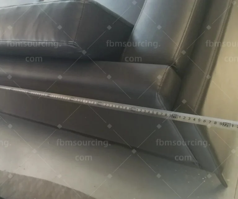 Leather sofa measured along its length with a tape at the inspection