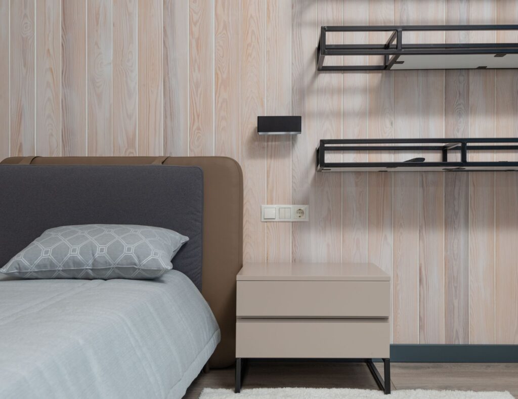 Compact bedroom with bed, built-in desk and shelving