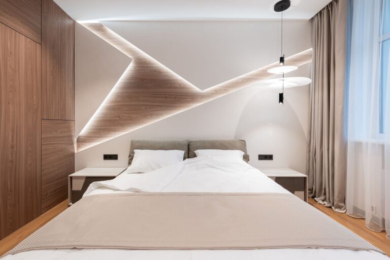 Hotel guestroom with walnut panelling and upholstered headboard