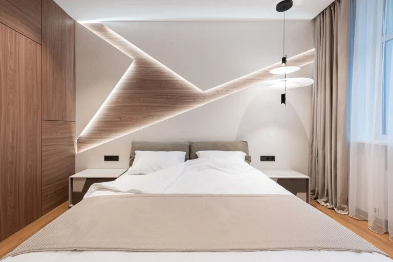 Hotel guestroom with walnut panelling and upholstered headboard