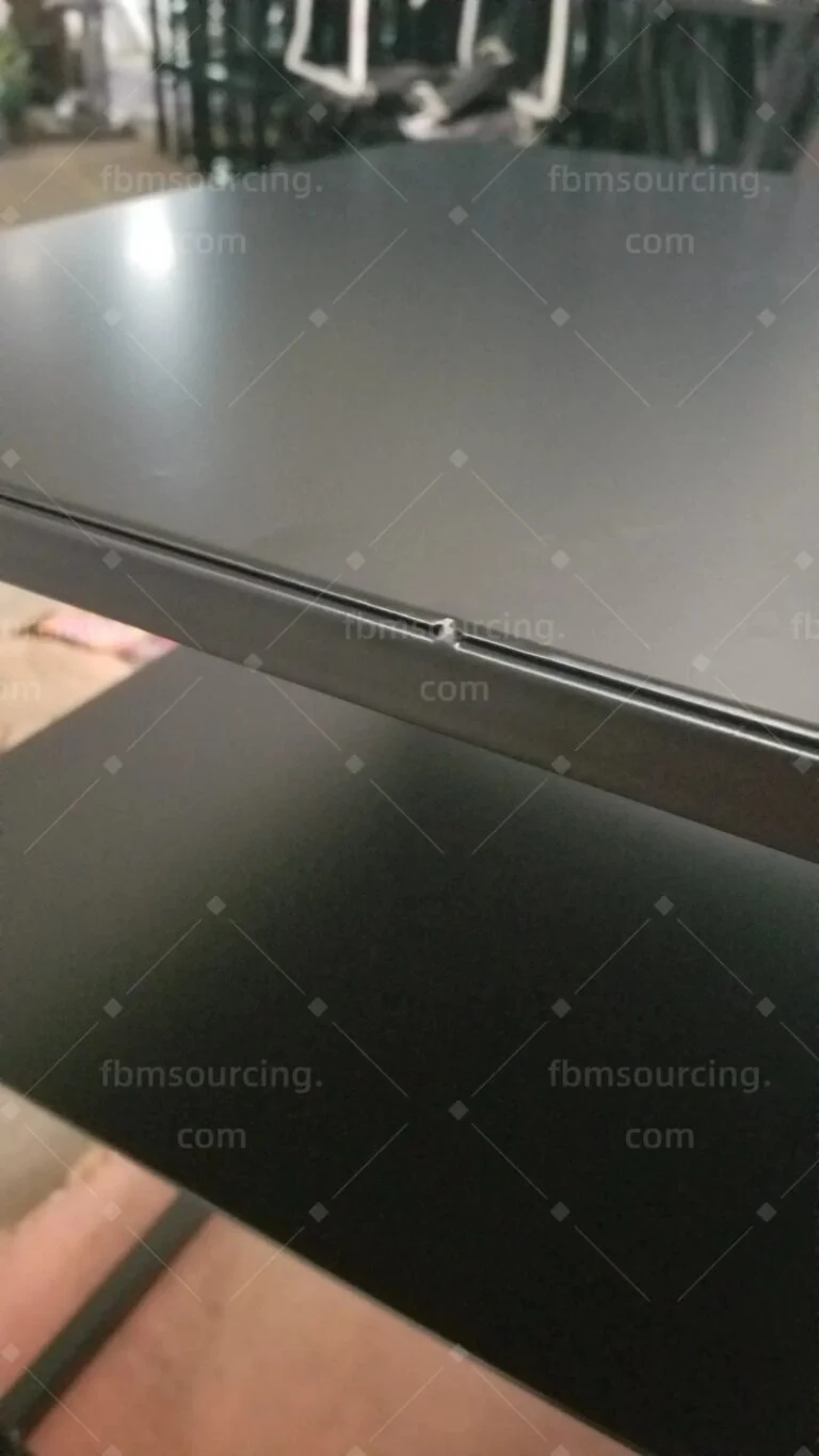 Black metal side table: top panel and lower shelf edge checked at the inspection