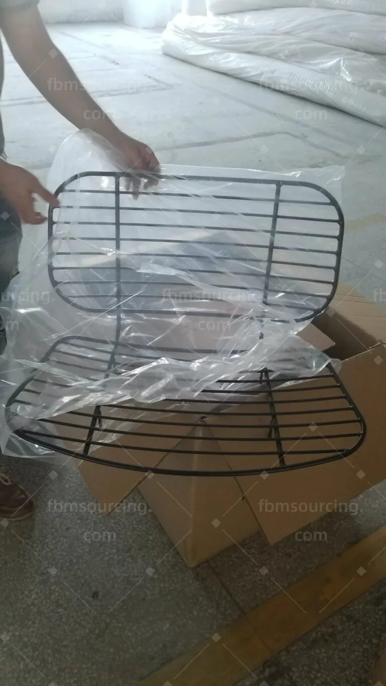 Black wire chair being bagged for export packing