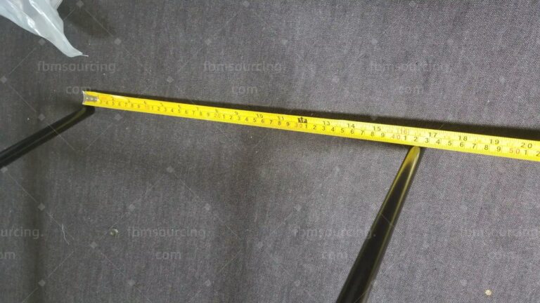 Wire chair leg span measured with a tape