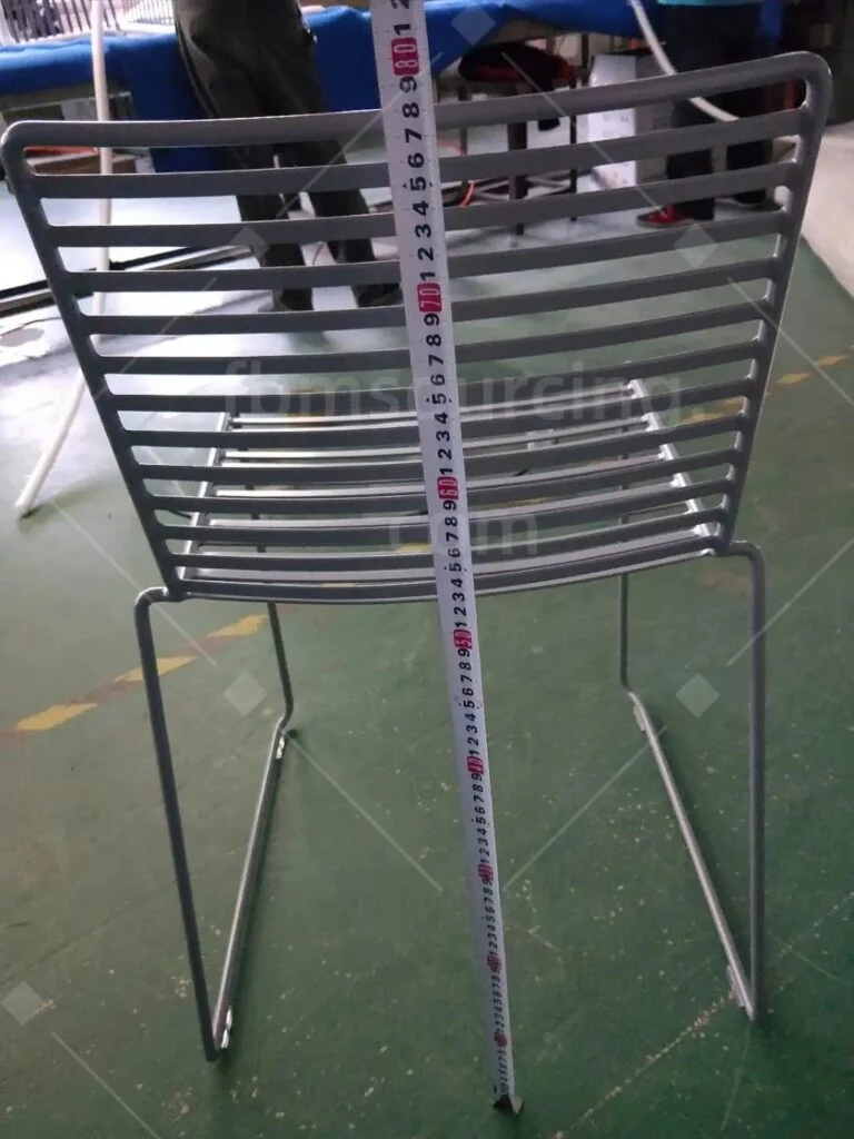 Steel wire chair height measured with a tape