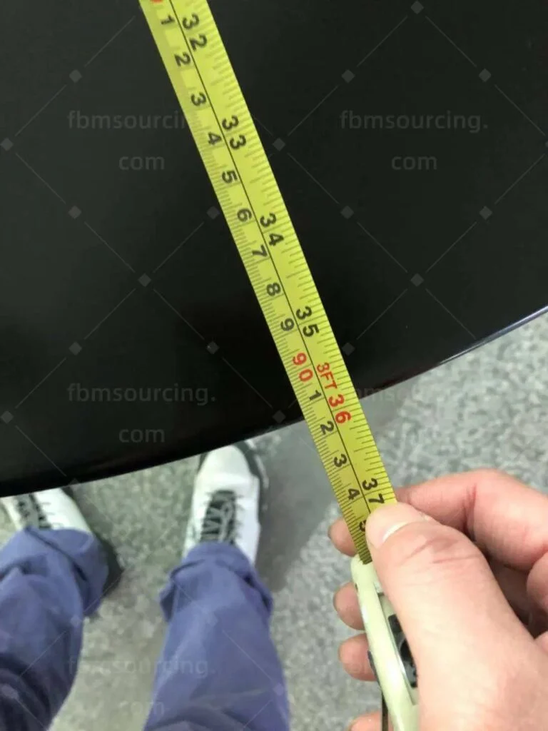 Edge of a dark round tabletop measured