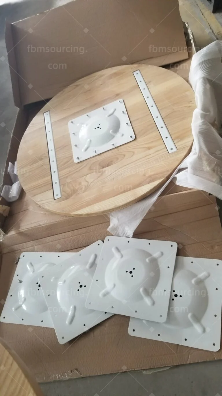 Round wood tabletop with fixing plates before packing