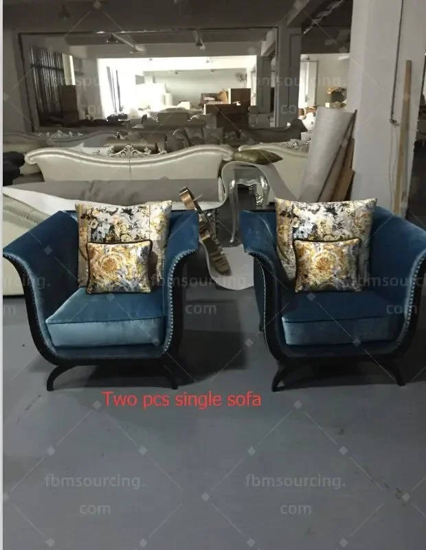 Two blue velvet armchairs with cushions
